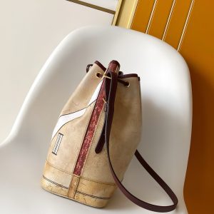 Alternative view of The iconic NOE handbag reimagined in WN leather for the Monogram Anniversary collection. Timeless beige hue. Monogram Jack lining and signature House motif with ultra-glossy brushed finish celebrating 130 years of distinctive luxury design. Gold-tone padlock and Louis Vuitton Paris stamp, crafted for true collectors.Dimensions: 27.5 x 36 x 20 cm (L x H x W). Features pearl-embossed leather inserts and "Louis Vuitton Paris" lettering. Includes one WN calf leather embroidered patch.Khaki leather trim. Capacity: Smartphone, headphones, coin purse, book, sunglasses, cosmetic case. Jacquard Monogram lining with gold-tone hardware. Shoulder strap: Detachable, adjustable length. Drawstring closure. Detachable commemorative emblem and (when shoulder-fixed) minimum strap length: 26.0 cm.Internal removable zippered monogram-patterned pouch. Maximum shoulder strap length (when fixed): 32.0 cm. Internal commemorative leather label. 2026 Spring/Summer Women's Handbag Crossbody Leather Bag. Region: Paris. Season: 2026 Spring/Summer. Brand: Louis Vuitton. Dimensions: 27.5 x 36 x 20 cm. Model: M27389.